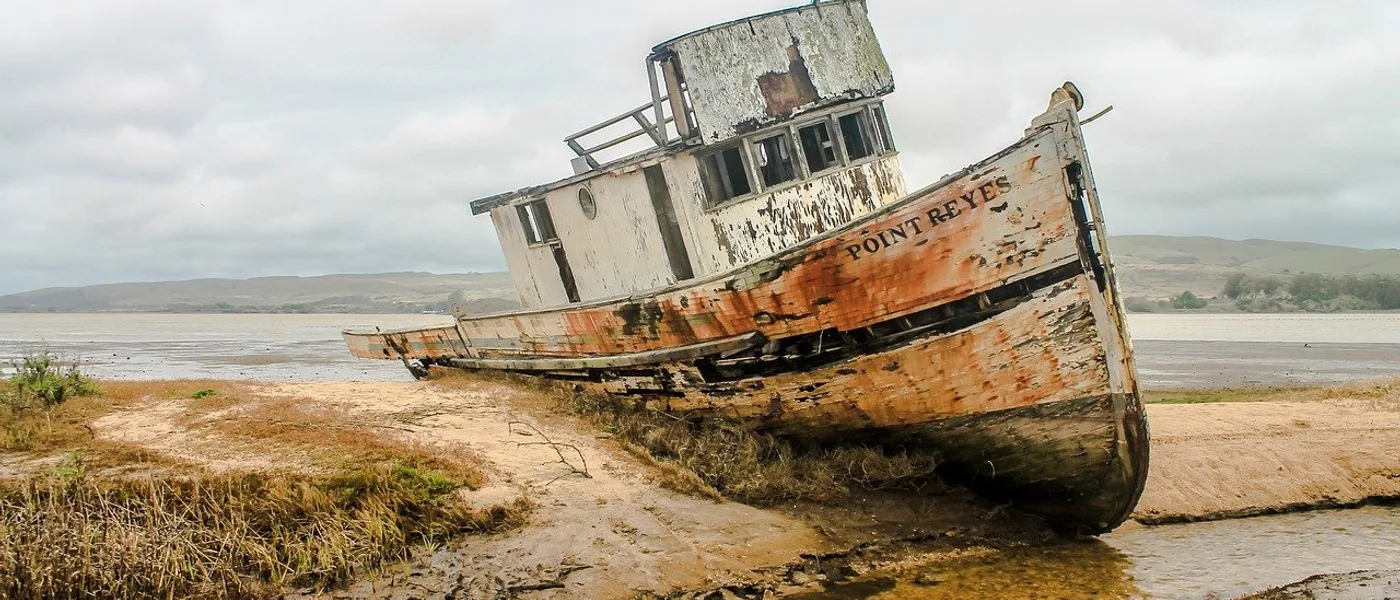 A weathered boat resting on the shore