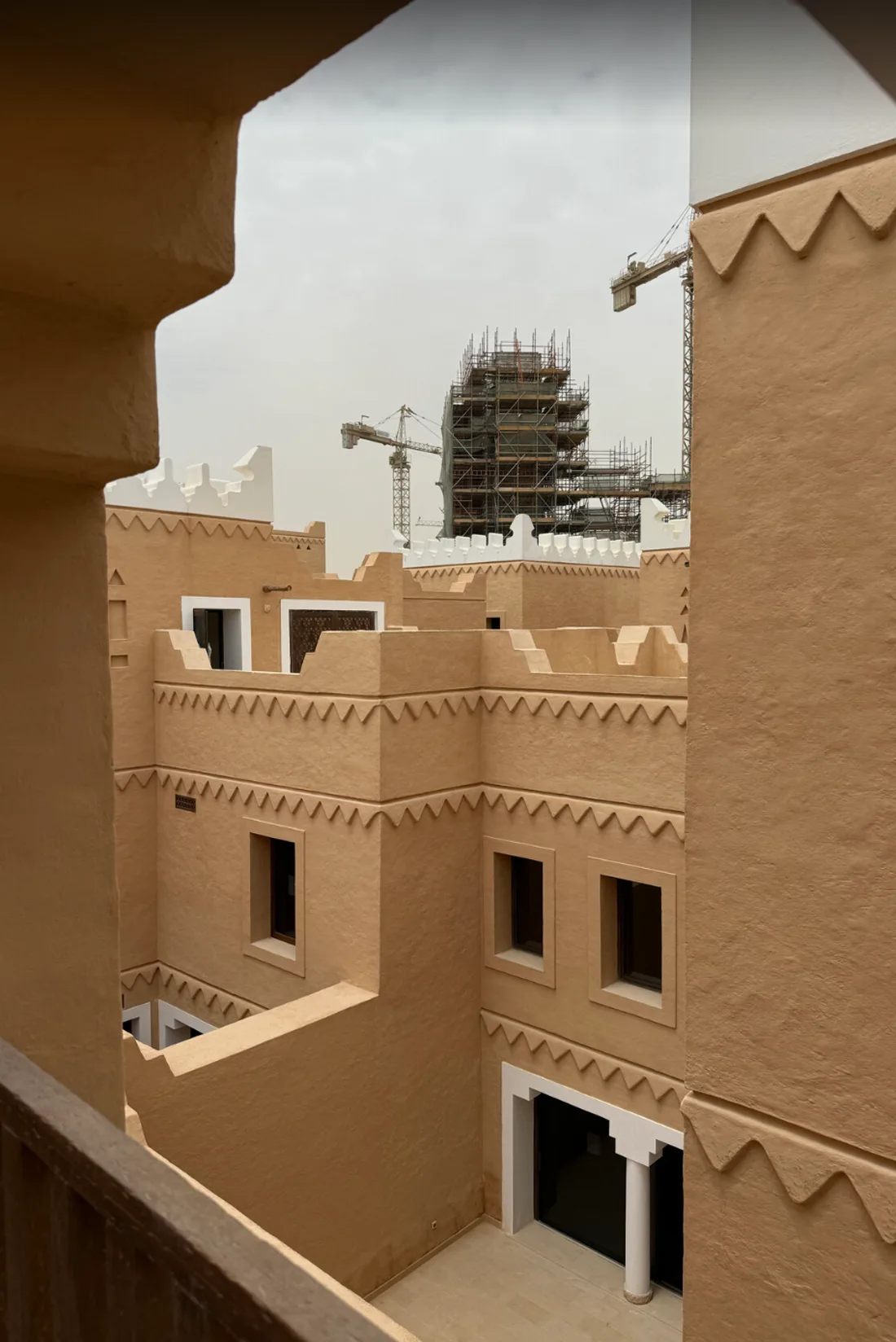 Najdi mud-brick architecture at Diriyah with construction rising behind it